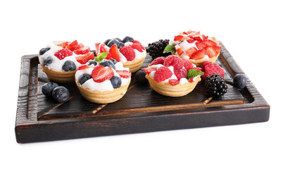 Board of tasty tartlets with whipped cream and berries on white background