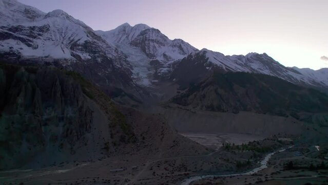 Aerial view beautiful landscape in Himalayas rover gorge. Manang district. Annapurna region, Nepal. Sunset behind snowy peaks in summer. Trekking trail in annapurna circuit trek.