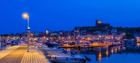 Foto auf Acrylglas Dunkelblau The port and a blue hour view at the castle of a small island and town of Marstrand, located in the municipality of Kungalv in southern Bohuslan, on the west coast
