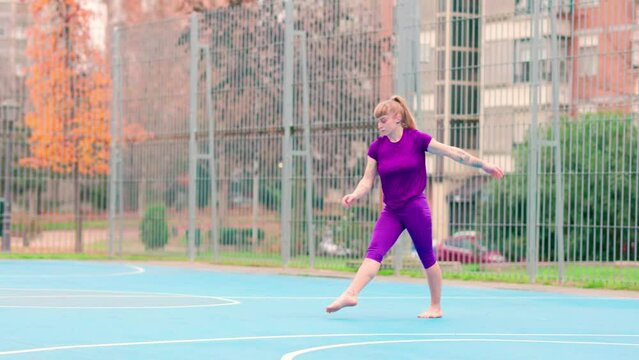 Cartwheel and backbend acrobatics exercise balance stretch. Hispanic flexible woman outdoors