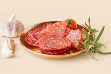 Plate with slices of tasty salami on yellow background
