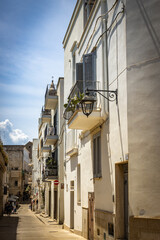 street in old town of monopoli, white facades, puglia, italy, bari, 