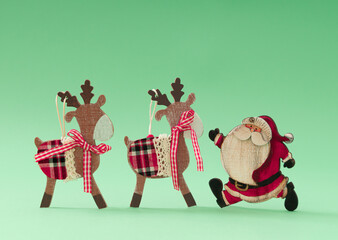 Christmas reindeers and Santa Claus against pastel green background. Minimal Christmas or New Year...