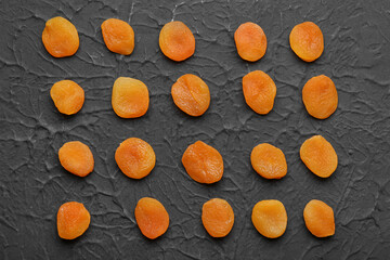 Tasty dried apricots on black background