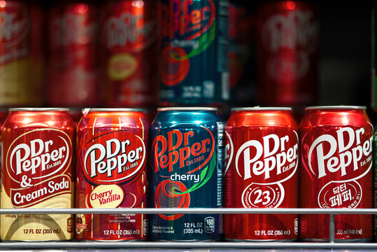 Minsk, Belarus. Jul 2, 2023. Dr Pepper soda cans on store shelf, popular soda beverage in aluminum cans. Various sodas standing in row, soft drinks on display.