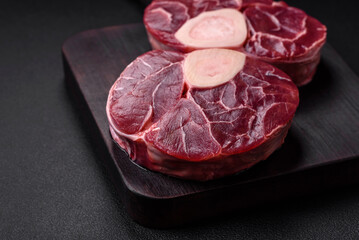 Fresh raw beef steak with bone or ossobuco with salt, spices and herbs