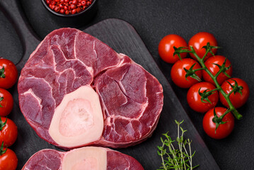 Fresh raw beef steak with bone or ossobuco with salt, spices and herbs
