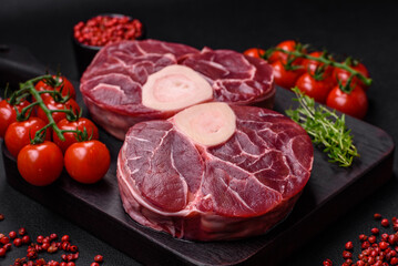 Fresh raw beef steak with bone or ossobuco with salt, spices and herbs