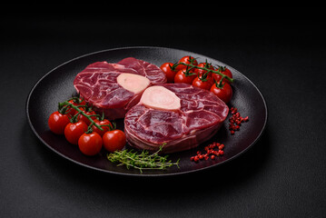 Fresh raw beef steak with bone or ossobuco with salt, spices and herbs
