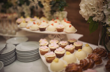 Delicious sweet buffet with cupcakes. Sweet holiday buffet with cupcakes and other desserts. Candy Bar. Dessert table for party goodies. Party reception, decorated delicious in the restaurant.