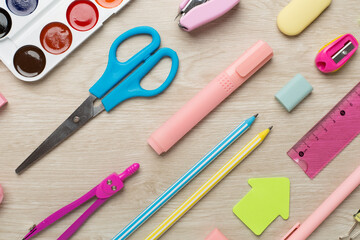 Flat lay with colorful school stationery on wooden backgroung, top view