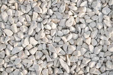 Texture of white pebbles. Small stones on the ground for landscape design.