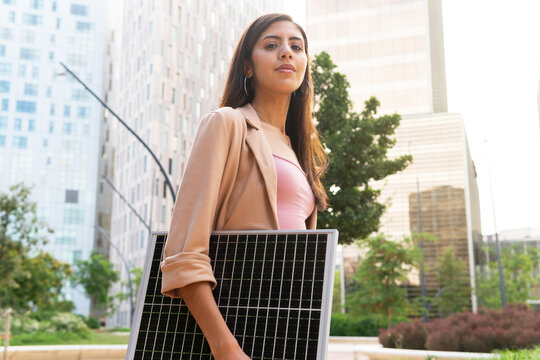Young businesswoman with solar panel
