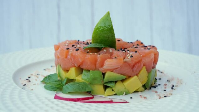 Salmon tartare with avocado, ceviche, rotates 360 degrees, close up
