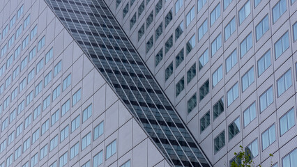 Obraz premium Exterior architecture of modern tall grey glass building