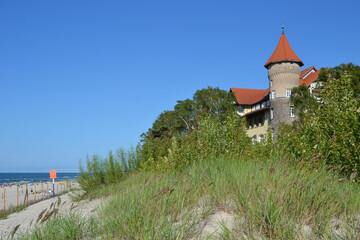 A view of historic hotel building on sand dune, Leba beach, Baltic Sea, Poland. Castle on the beach. Beautiful sunny weather © PaulSat