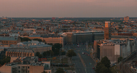 Summer sunset in Riga, Latvia. Aerial view of Riga, the capital of Latvia at sunset. Beautiful buildings, bridges and transport going through the city.