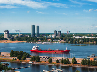 Tanker in the middle of the river turning around. Huge industrial ship in Riga.