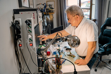 Successful mature engineer working in home office, workshop. Concept of constructing