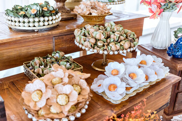 trays with party brigadeiros on top of a wooden table