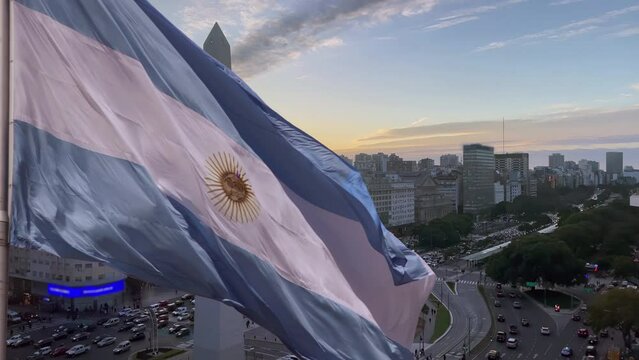 Flag of Argentina Over Buenos Aires City at Sunset.