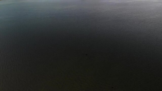 Aerial shot over water in the Kyle of Tongue with Ben Loyal in the background