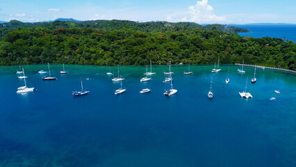 Fototapeta na wymiar Sailing yachts in the marina. Aerial view of sailing yachts in the lagoon off the coast of a tropical island.