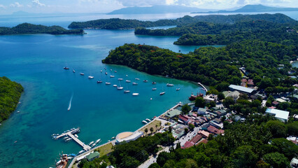 Sailing yachts in the marina. Aerial view of sailing yachts in the lagoon near the town on the coast of a tropical island.