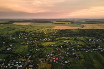 Aerial view of residential houses in suburban rural area at sunset