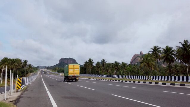 A Midday clip of a Picturesque Express Highway and the traffic movement in the rocky mountain range in  Karnataka, India.