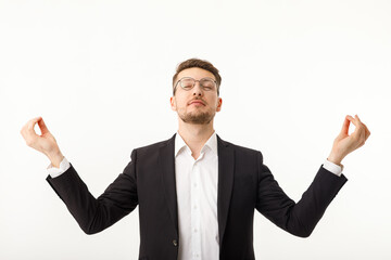 Businessman meditating with closed eyes isolated on white background.