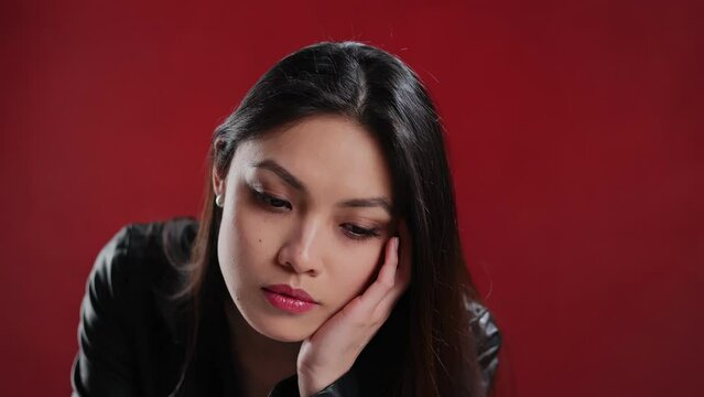 Young Asian woman in a leather jacket poses for the camera - extreme slow motion