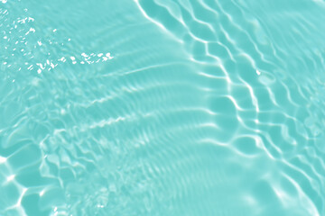 Blue water with ripples on the surface. Defocus blurred transparent blue colored clear calm water...