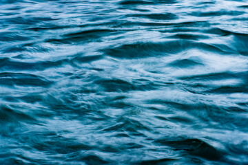 macro blue wave pattern in a river with motion blur