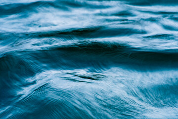 macro blue wave pattern in a river with motion blur