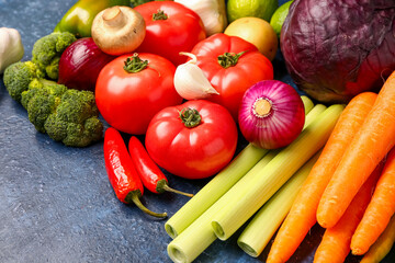 Different fresh vegetables on blue background