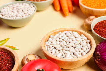 Different fresh vegetables and cereals on yellow background, closeup