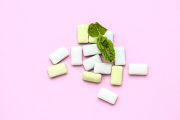 Fresh chewing gums with mint on pink background