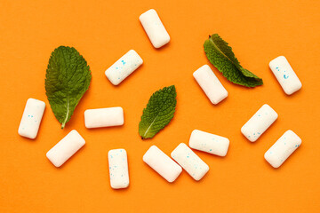 Fresh chewing gums with mint on orange background