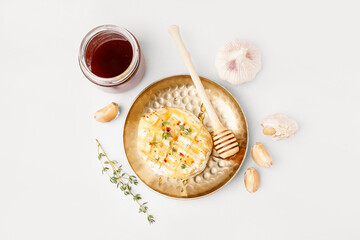 Plate with tasty baked Camembert cheese on grey background