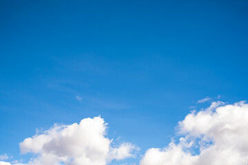 Clear blue sky above and with clouds below, background use