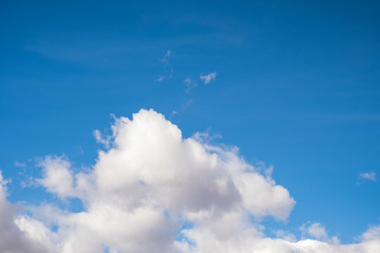 Fluffy clouds in blue sky, image for background use, horizontal photo