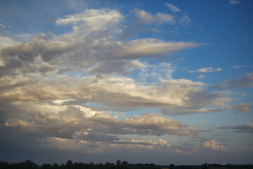 Fototapeta na wymiar Beautiful blue sky with wispy white cumulus clouds