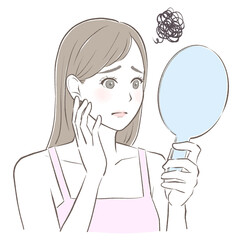 手鏡を見て肌に悩む女性