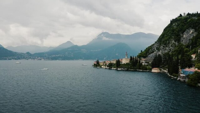 Drone shot approaching Italy's town of Varenna on Lake Como.