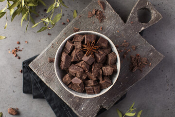 Cubes of dark artisan chocolate in a bowl. Bitter chocolate