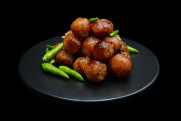 Hot small sausages topped with fresh chili peppers.