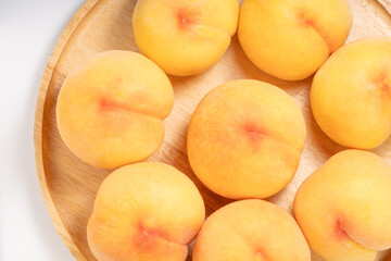 Yellow Peach with sliced on white Background, Fresh peach in wooden basket on white Background.