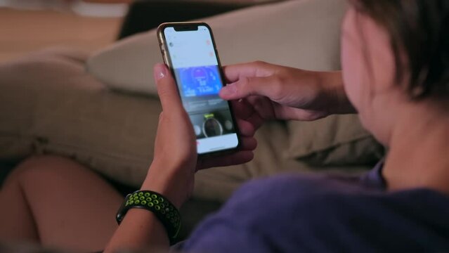 close-up of procrastinating person sitting on couch at home checking emails and browsing news on social networks studying videos on online platforms internet space