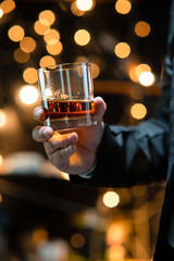 Businessman sitting and holding glass of whiskey